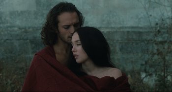 Movie still from “Queen Margot” (1994), directed by Patrice Chéreau – A man and a woman wrapped in a red blanket; Close Up shot, Low angle