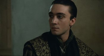 Movie still from “Queen Margot” (1994), directed by Patrice Chéreau – A person wearing a jacket; Close Up shot, Over the shoulder angle