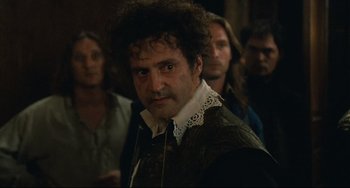 Movie still from “Queen Margot” (1994), directed by Patrice Chéreau – A group of people standing in a room; Close Up shot, Over the shoulder angle