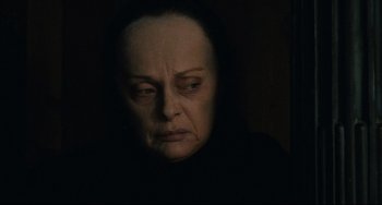 Movie still from “Queen Margot” (1994), directed by Patrice Chéreau – An older woman with a sad look on her face; Close Up shot, Over the shoulder angle