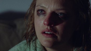 Movie still from “Queen of Earth” (2015), directed by Alex Ross Perry – A person with a crying look on their face; Close Up shot, High angle
