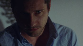 Movie still from “Queen of Earth” (2015), directed by Alex Ross Perry – A man's face in the dark; Close Up shot, Over the shoulder angle