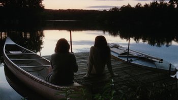 Movie still from “Queen of Earth” (2015), directed by Alex Ross Perry – Two women sitting on a dock looking out over a lake; Wide shot, Over the shoulder angle
