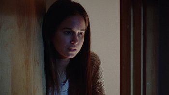 Movie still from “Queen of Earth” (2015), directed by Alex Ross Perry – A young woman leaning against a wall with her head on the wall; Close Up shot, High angle