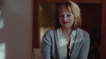 Movie still from “Queen of Earth” (2015), directed by Alex Ross Perry – A woman sitting at a table with a bottle of beer; Close Up shot, Over the shoulder angle