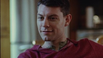 Movie still from “Queen of Earth” (2015), directed by Alex Ross Perry – A person wearing a red shirt; Close Up shot, Low angle