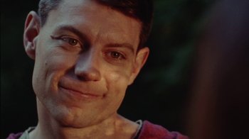 Movie still from “Queen of Earth” (2015), directed by Alex Ross Perry – A man's face in a red shirt; Close Up shot, Low angle