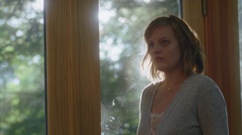 Movie still from “Queen of Earth” (2015), directed by Alex Ross Perry – A woman standing in front of a window; Close Up shot, Low angle