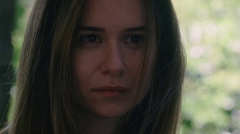 Movie still from “Queen of Earth” (2015), directed by Alex Ross Perry – A person with long hair; Close Up shot, Over the shoulder angle