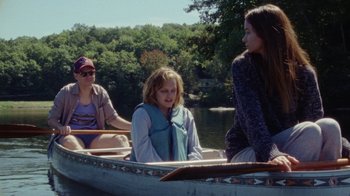 Movie still from “Queen of Earth” (2015), directed by Alex Ross Perry – Three people in a boat on a river; Wide shot, Over the shoulder angle