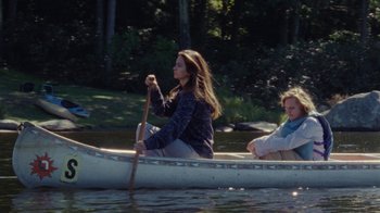 Movie still from “Queen of Earth” (2015), directed by Alex Ross Perry – Two people are rowing a boat on a river; Wide shot, High angle