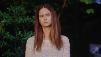 Movie still from “Queen of Earth” (2015), directed by Alex Ross Perry – A woman with long brown hair wearing a white sweater; Close Up shot, Low angle