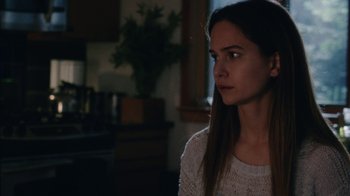 Movie still from “Queen of Earth” (2015), directed by Alex Ross Perry – A woman in a white sweater is looking to her left; Close Up shot, Over the shoulder angle