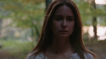 Movie still from “Queen of Earth” (2015), directed by Alex Ross Perry – A woman with long brown hair wearing a white dress; Close Up shot, Low angle