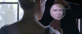 Movie still from “Queen of the Desert” (2015), directed by Werner Herzog – A woman looking at her reflection in a mirror; Close Up shot, Over the shoulder angle
