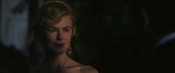 Movie still from “Queen of the Desert” (2015), directed by Werner Herzog – A beautiful woman with blonde hair wearing a necklace and earrings; Close Up shot, Over the shoulder angle
