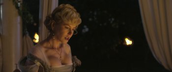 Movie still from “Queen of the Desert” (2015), directed by Werner Herzog – A beautiful woman with blonde hair wearing a white dress; Close Up shot, Low angle