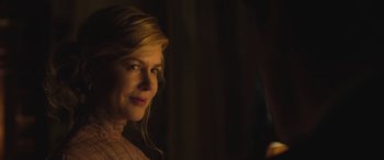 Movie still from “Queen of the Desert” (2015), directed by Werner Herzog – A woman with long blonde hair is smiling for the camera; Close Up shot, Over the shoulder angle