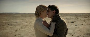 Movie still from “Queen of the Desert” (2015), directed by Werner Herzog – A man and a woman kissing on the beach; Close Up shot, Low angle