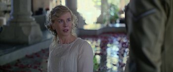 Movie still from “Queen of the Desert” (2015), directed by Werner Herzog – A woman in a white dress standing in front of a pond; Close Up shot, Over the shoulder angle