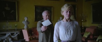 Movie still from “Queen of the Desert” (2015), directed by Werner Herzog – An older man and a younger woman holding a piece of paper; Medium shot, Over the shoulder angle