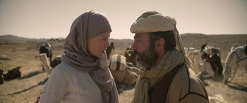 Movie still from “Queen of the Desert” (2015), directed by Werner Herzog – A man and a woman talking to each other in the desert; Medium shot, Over the shoulder angle