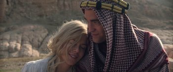 Movie still from “Queen of the Desert” (2015), directed by Werner Herzog – A man and a woman are hugging each other; Close Up shot, Low angle