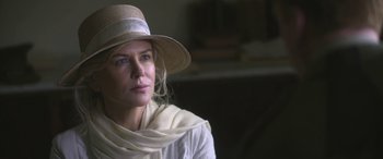 Movie still from “Queen of the Desert” (2015), directed by Werner Herzog – A woman wearing a straw hat and a white scarf; Close Up shot, Over the shoulder angle