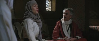 Movie still from “Queen of the Desert” (2015), directed by Werner Herzog – A man and a woman sitting next to each other; Medium shot, Over the shoulder angle