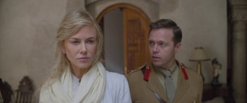 Movie still from “Queen of the Desert” (2015), directed by Werner Herzog – A man and a woman standing next to each other in front of a doorway; Close Up shot, Over the shoulder angle
