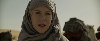 Movie still from “Queen of the Desert” (2015), directed by Werner Herzog – A person wearing a headscarf; Close Up shot, Low angle