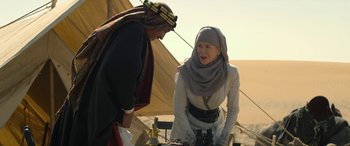 Movie still from “Queen of the Desert” (2015), directed by Werner Herzog – A woman wearing a headscarf talking to a man; Medium shot, Over the shoulder angle
