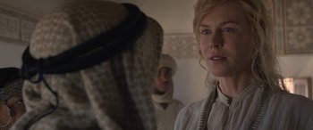 Movie still from “Queen of the Desert” (2015), directed by Werner Herzog – A woman standing next to a man wearing a white shirt; Close Up shot, Over the shoulder angle