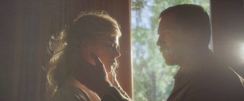 Movie still from “Queen of the Desert” (2015), directed by Werner Herzog – A man and a woman face to face in front of a window; Close Up shot, Low angle