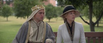 Movie still from “Queen of the Desert” (2015), directed by Werner Herzog – A man and a woman sitting next to each other on a park bench; Medium shot, Over the shoulder angle