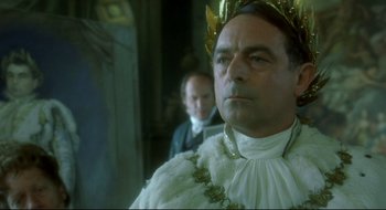 Movie still from “Quills” (2000), directed by Philip Kaufman – A person wearing a crown; Close Up shot, Low angle