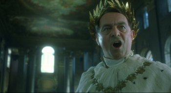 Movie still from “Quills” (2000), directed by Philip Kaufman – A person wearing a crown; Close Up shot, Low angle