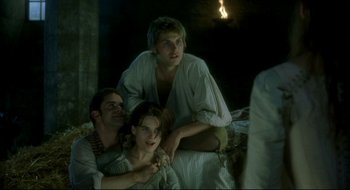 Movie still from “Quills” (2000), directed by Philip Kaufman – A group of people sitting on top of a bed; Medium shot, Over the shoulder angle
