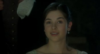 Movie still from “Quills” (2000), directed by Philip Kaufman – A young woman is smiling for the camera; Close Up shot, Over the shoulder angle