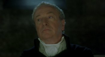 Movie still from “Quills” (2000), directed by Philip Kaufman – An older man in a black jacket looking up; Close Up shot, Over the shoulder angle