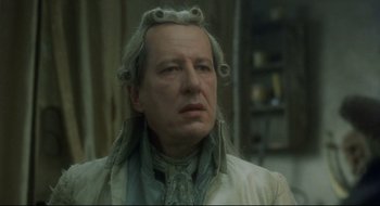 Movie still from “Quills” (2000), directed by Philip Kaufman – An older man with long white hair wearing a wig; Close Up shot, Over the shoulder angle