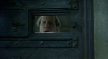 Movie still from “Quills” (2000), directed by Philip Kaufman – A man looking at himself in a mirror; Close Up shot, Low angle