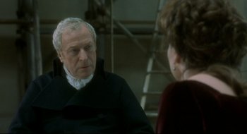 Movie still from “Quills” (2000), directed by Philip Kaufman – An older man and a younger woman are talking to each other; Close Up shot, Over the shoulder angle