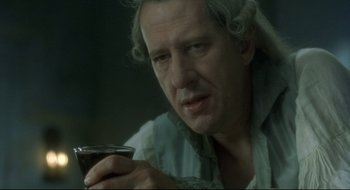 Movie still from “Quills” (2000), directed by Philip Kaufman – An older man holding a wine glass in his hand; Close Up shot, Over the shoulder angle