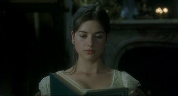 Movie still from “Quills” (2000), directed by Philip Kaufman – A young woman is reading a book in a room; Close Up shot, Over the shoulder angle