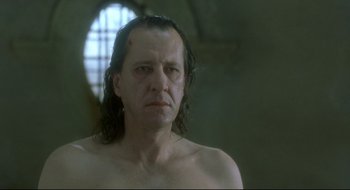 Movie still from “Quills” (2000), directed by Philip Kaufman – A man with long black hair is looking at the camera; Close Up shot, Low angle