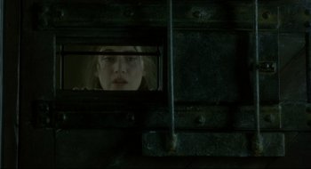Movie still from “Quills” (2000), directed by Philip Kaufman – A woman looking through a window in a train car; Extreme Close Up shot, Low angle