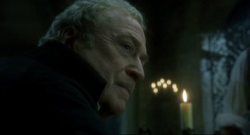 Movie still from “Quills” (2000), directed by Philip Kaufman – An older man looking at a candle in the dark; Close Up shot, Low angle