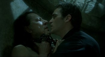 Movie still from “Quills” (2000), directed by Philip Kaufman – A man and a woman kissing in a dark room; Close Up shot, Over the shoulder angle