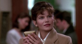Movie still from “Raising Cain” (1992), directed by Brian De Palma – A person holding a book; Close Up shot, Low angle